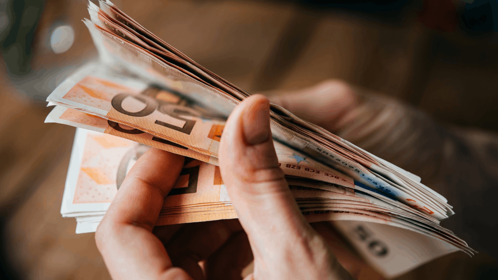 Hände zählen ein Bündel Euro-Geldscheine